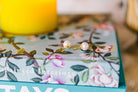 Bloom Pearl Hook earrings displayed on floral print book_m donohue collection